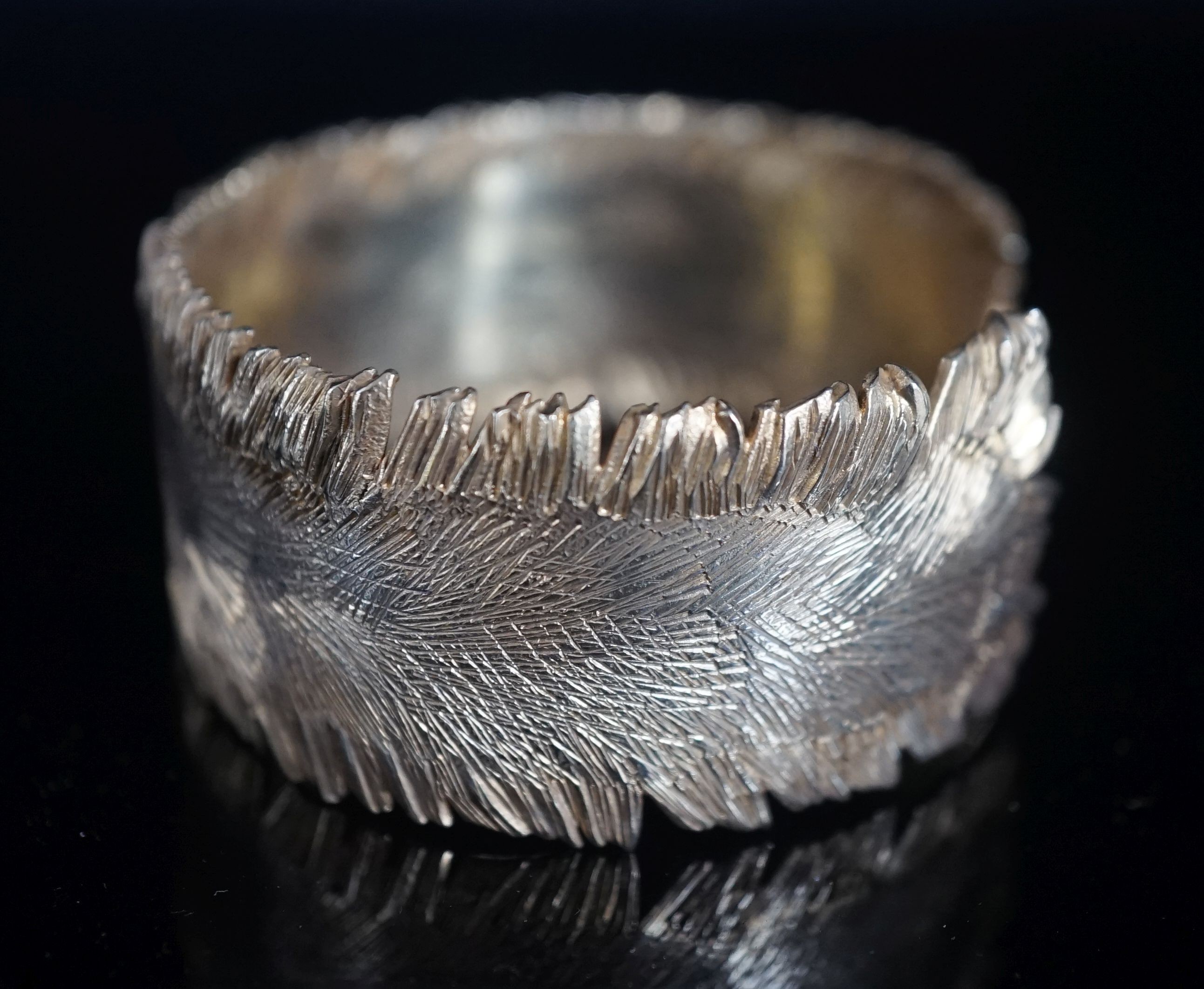 A modern silver gilt open bangle by Adrian Gerald Benney, London, 1962, with samorodok decoration, in original box, interior diameter approx. 60mm, 48 grams.